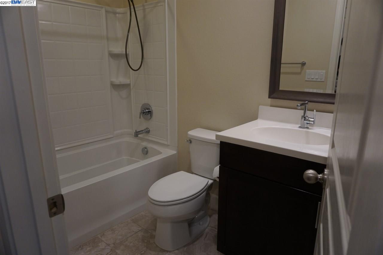 4728 Norris Canyon Road, Unit 205 San Ramon, CA 94583 - Photo 9 of 18 a bathroom with a granite countertop bathtub shower sink vanity and toilet