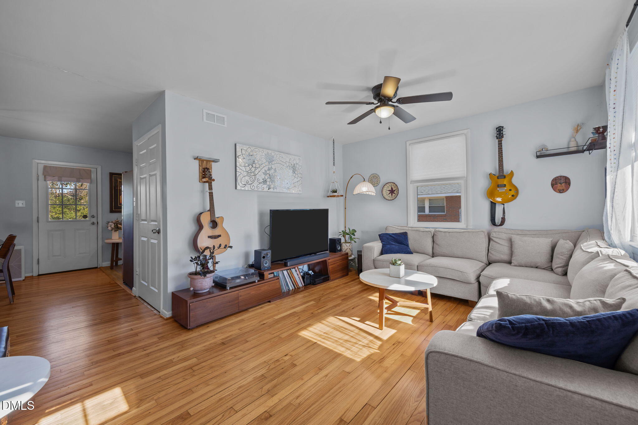 823 Hadley Road Raleigh, NC 27610 - Photo 12 of 35 a living room with furniture a fireplace and a flat screen tv