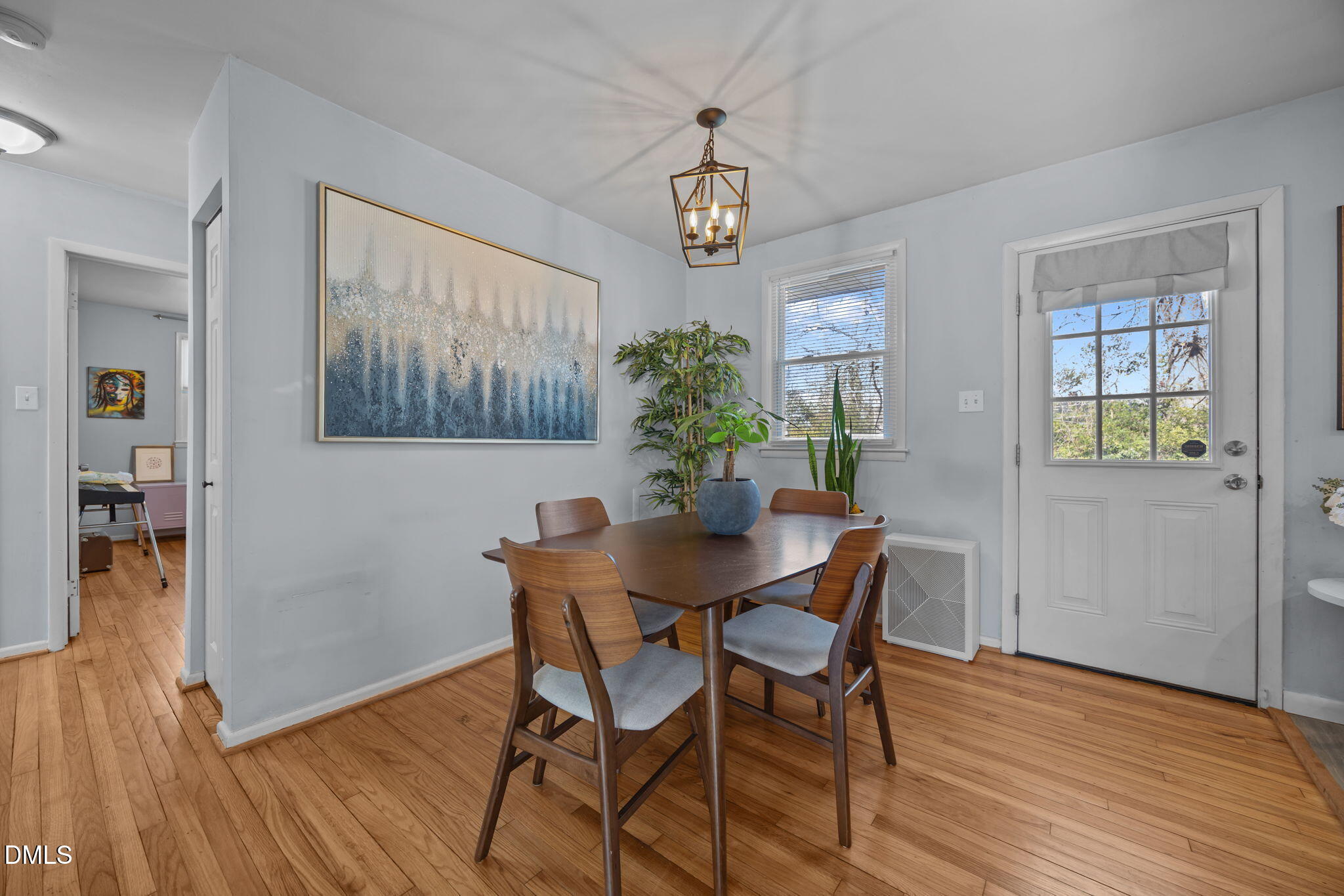 823 Hadley Road Raleigh, NC 27610 - Photo 15 of 35 a view of a dining room with furniture wooden floor and a chandelier