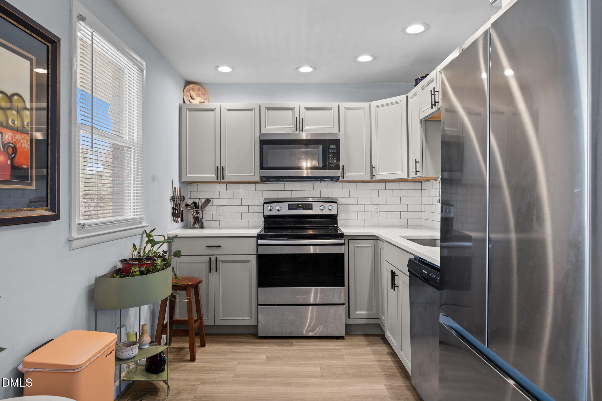 823 Hadley Road Raleigh, NC 27610 - Photo 17 of 35 a kitchen with a stove and a refrigerator