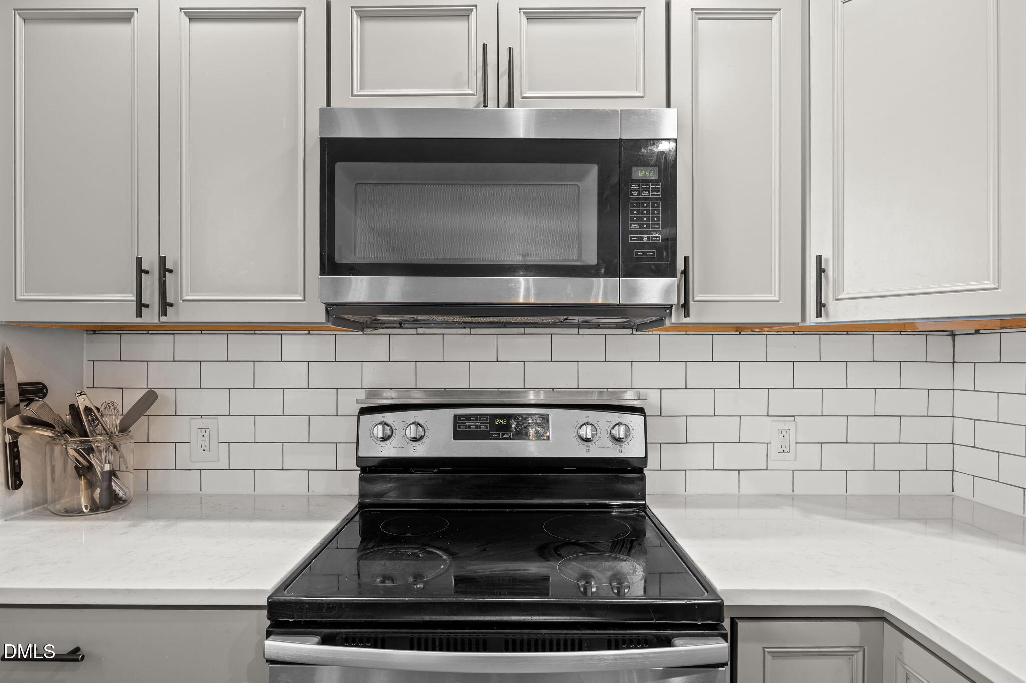 823 Hadley Road Raleigh, NC 27610 - Photo 19 of 35 a kitchen with microwave cabinets and stove