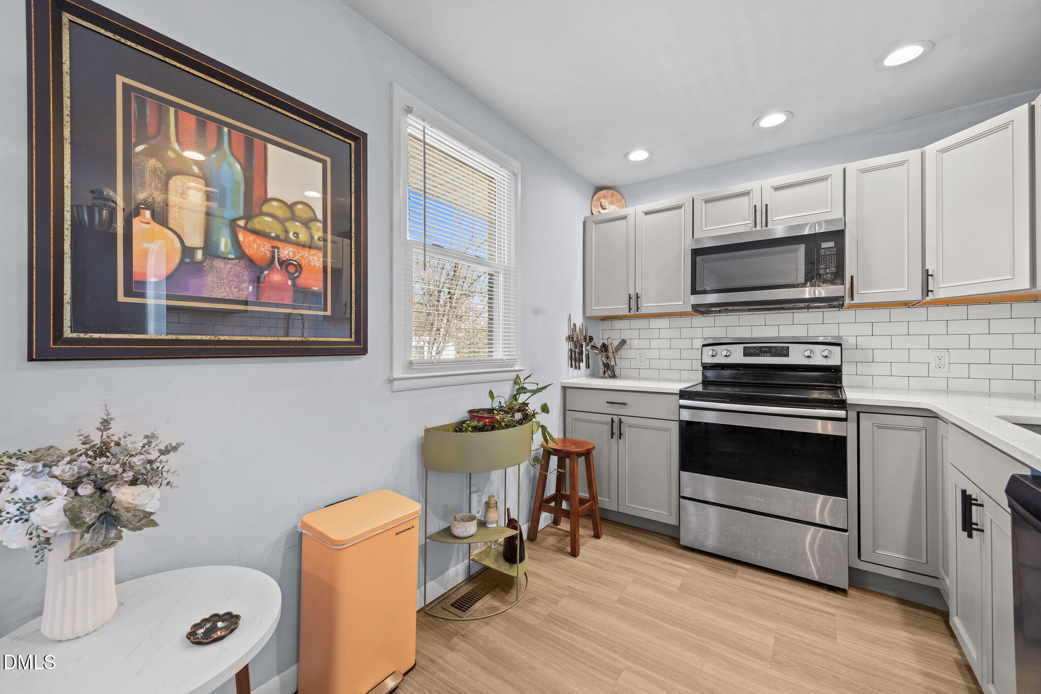 823 Hadley Road Raleigh, NC 27610 - Photo 22 of 35 a kitchen with stainless steel appliances a stove a sink and a microwave