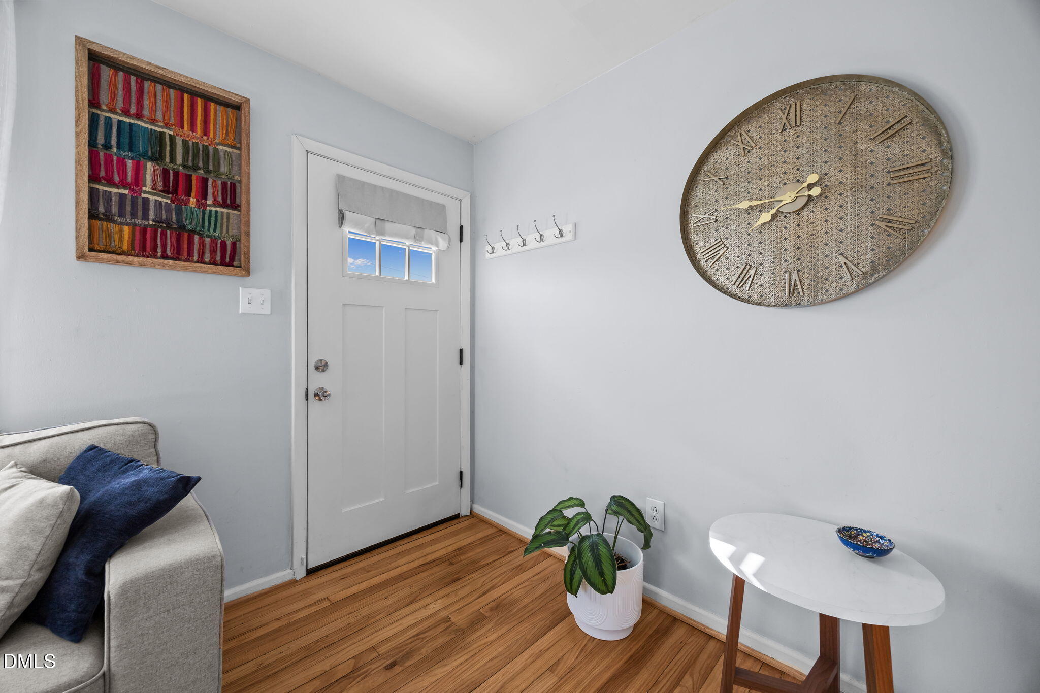 823 Hadley Road Raleigh, NC 27610 - Photo 24 of 35 a view of a hallway with wooden floor and glass windows