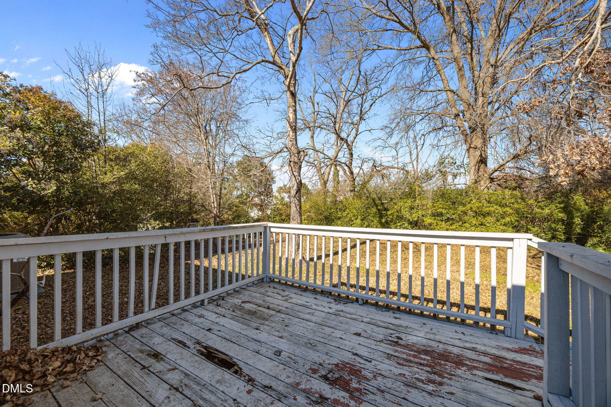 823 Hadley Road Raleigh, NC 27610 - Photo 34 of 35 a wooden deck with trees in front of it