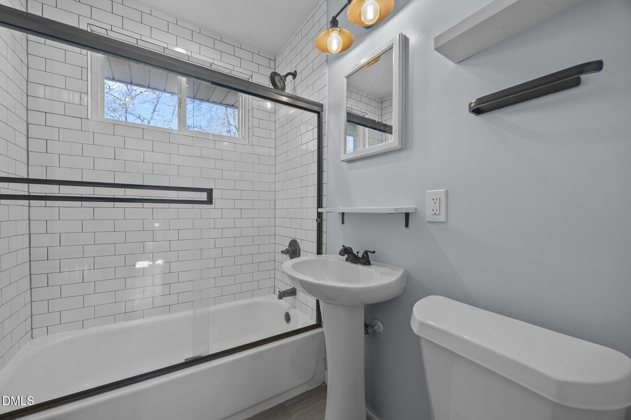823 Hadley Road Raleigh, NC 27610 - Photo 10 of 35 a bathroom with a sink a toilet and shower