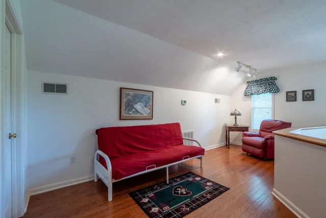 a living room with furniture and wooden floor