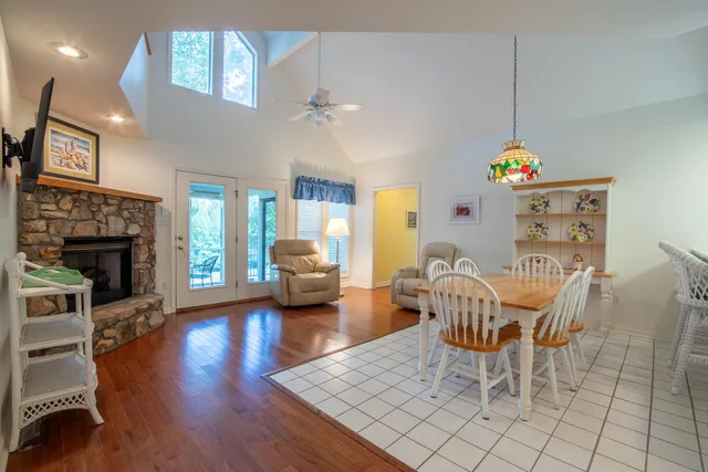 a dining room with furniture a chandelier and wooden floor