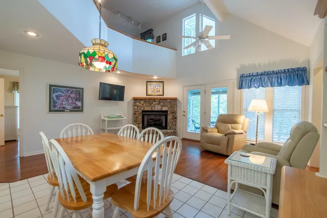 a view of a dining room with furniture a chandelier and wooden floor