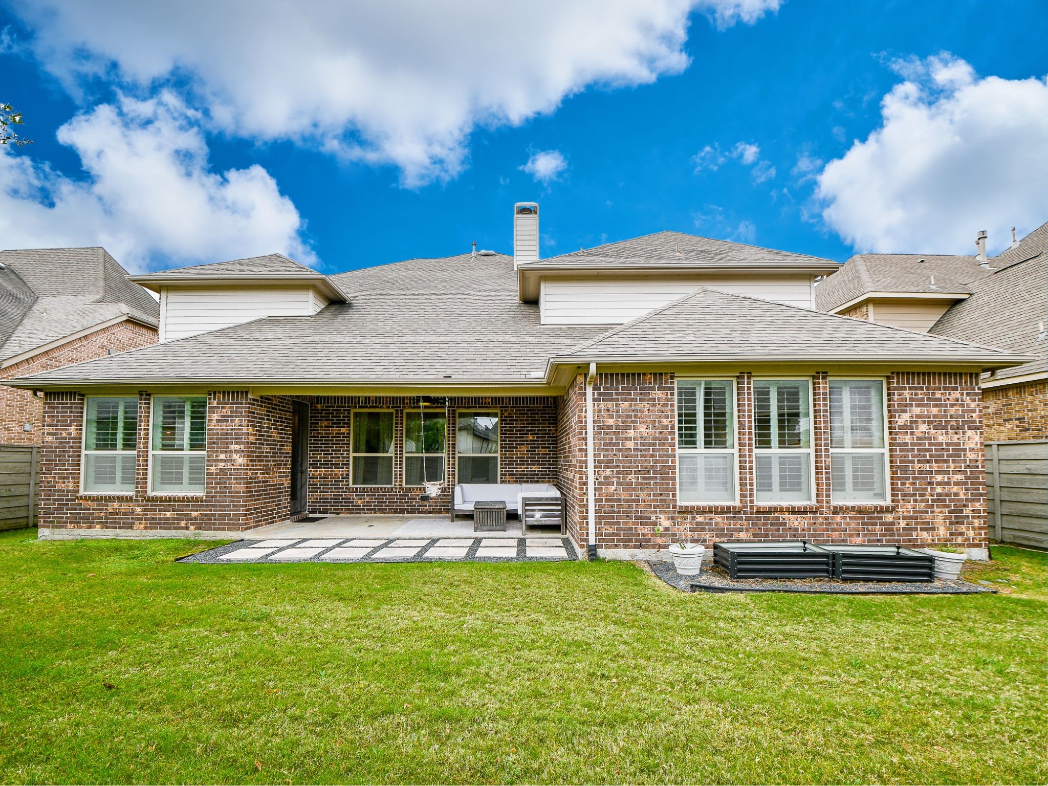4523 Juniper Ridge Lane Manvel, TX 77578 - Photo 36 of 38 a front view of a house with a garden and patio