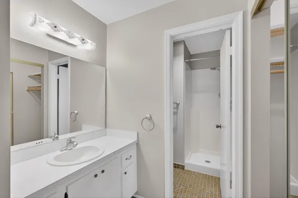 a kitchen with stainless steel appliances granite countertop white cabinets and a refrigerator