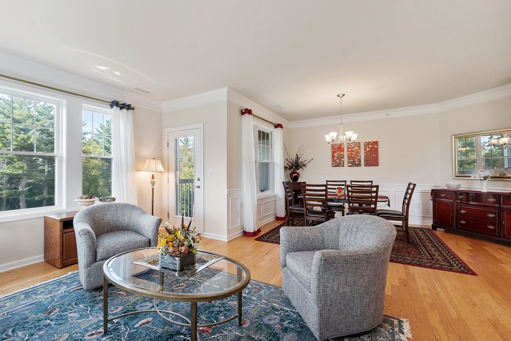 2 Francis Drive, Unit 412 Andover, MA 01810 - Photo 12 of 33 a living room with furniture and a wooden floor