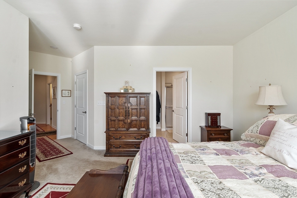 2 Francis Drive, Unit 412 Andover, MA 01810 - Photo 14 of 33 a bedroom with a bed and a dresser