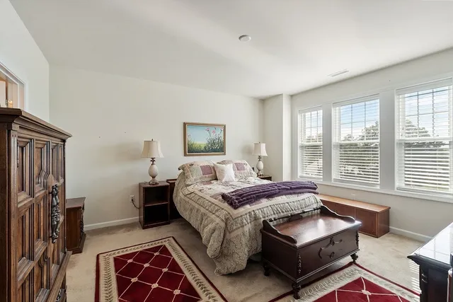 a bedroom with a bed couch and a window