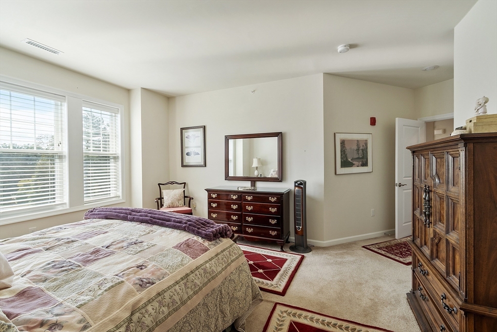 2 Francis Drive, Unit 412 Andover, MA 01810 - Photo 16 of 33 a bedroom with a bed and furniture