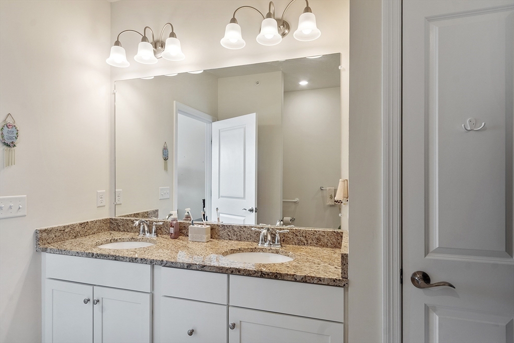 2 Francis Drive, Unit 412 Andover, MA 01810 - Photo 17 of 33 a bathroom with a granite countertop double vanity sinks and a mirror