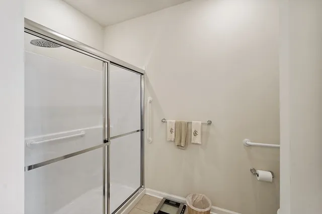 a bathroom with a glass shower door