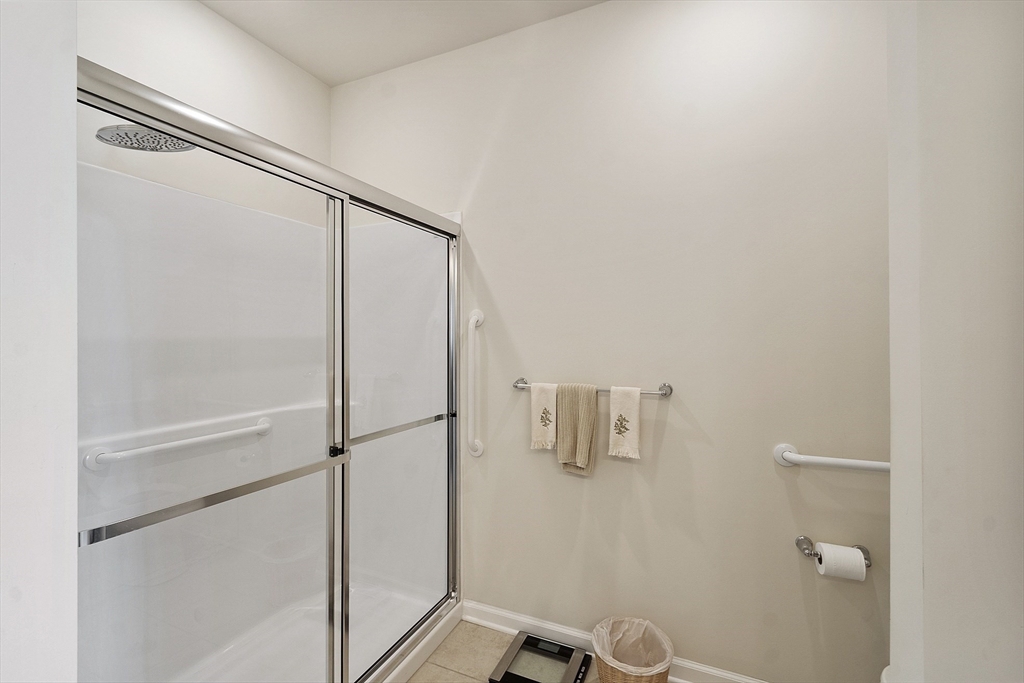 2 Francis Drive, Unit 412 Andover, MA 01810 - Photo 18 of 33 a bathroom with a glass shower door