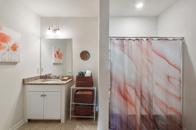 a utility room with a sink and cabinets