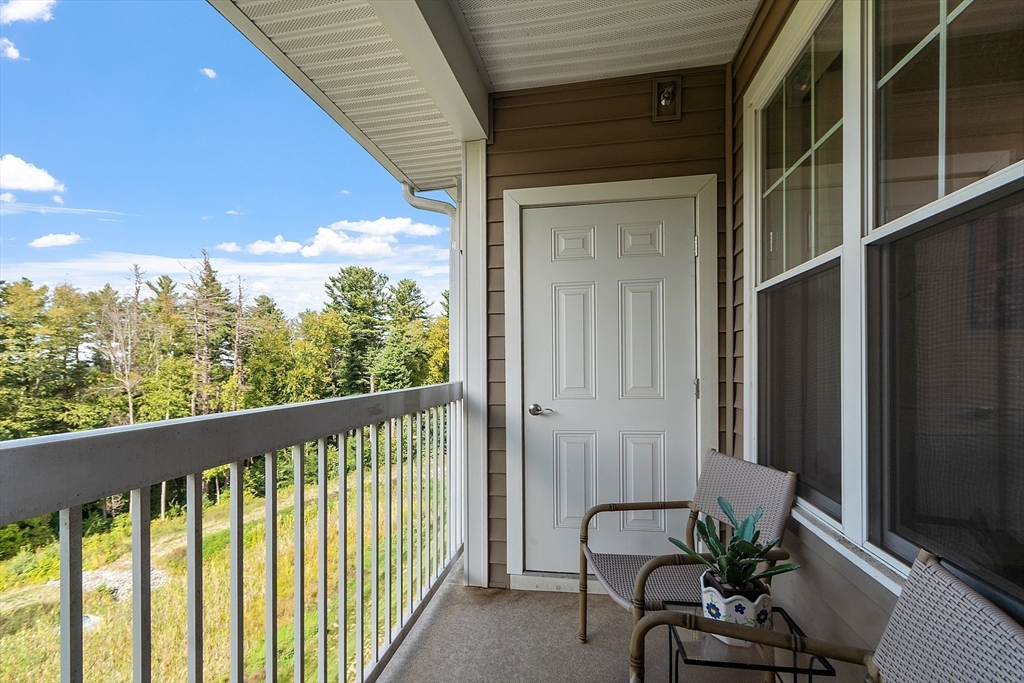 2 Francis Drive, Unit 412 Andover, MA 01810 - Photo 23 of 33 a balcony with furniture and potted plants