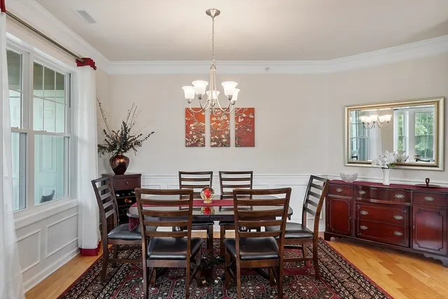 a view of a dining room with furniture and chandelier