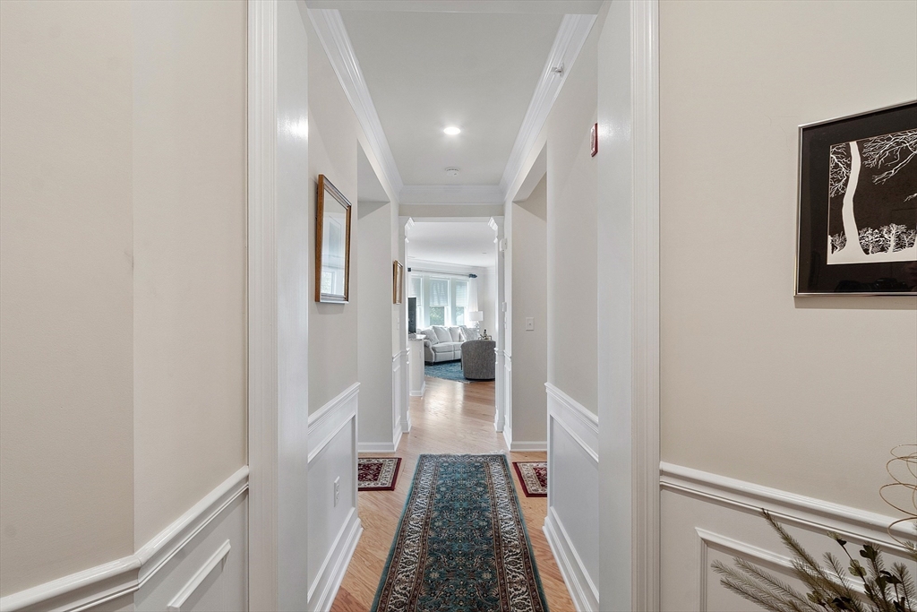2 Francis Drive, Unit 412 Andover, MA 01810 - Photo 7 of 33 a view of a hallway with wooden floor and staircase