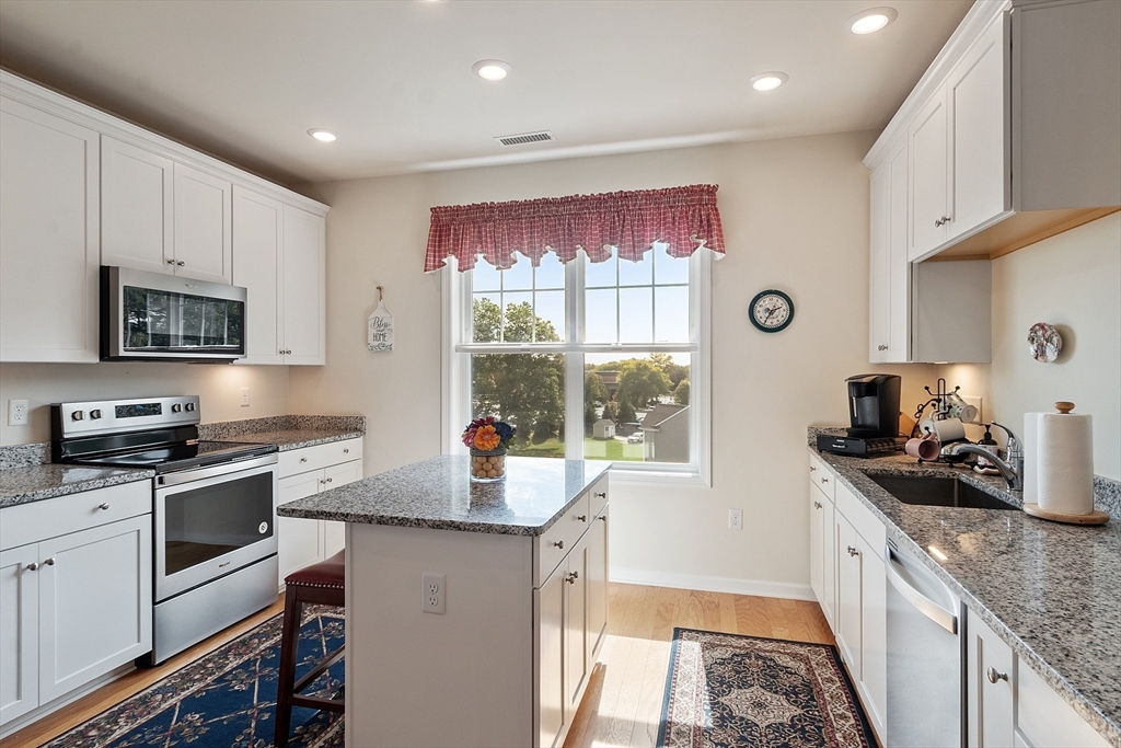 2 Francis Drive, Unit 412 Andover, MA 01810 - Photo 8 of 33 a kitchen with a sink stove top oven and refrigerator