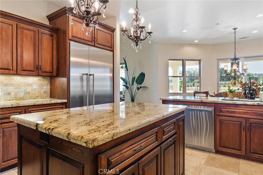 18205 Walnut Avenue Atascadero, CA 93422 - Photo 11 of 46 a kitchen with kitchen island granite countertop a sink and center island