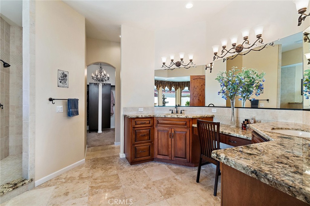 18205 Walnut Avenue Atascadero, CA 93422 - Photo 16 of 46 a bathroom with a granite countertop sink a mirror and a shower