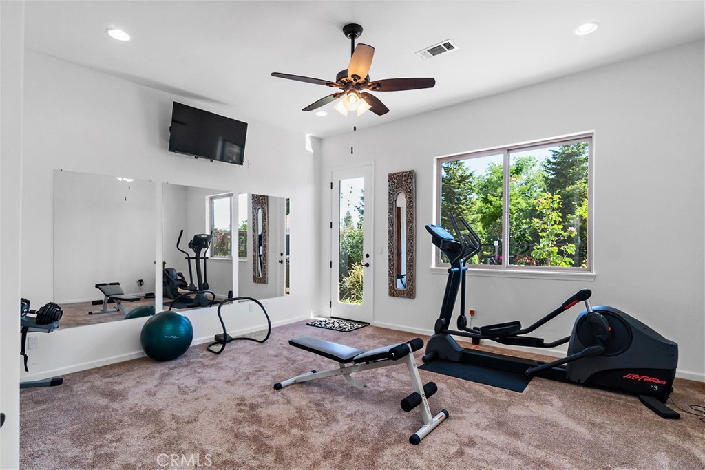 18205 Walnut Avenue Atascadero, CA 93422 - Photo 23 of 46 a living room with furniture gym equipment and a large window
