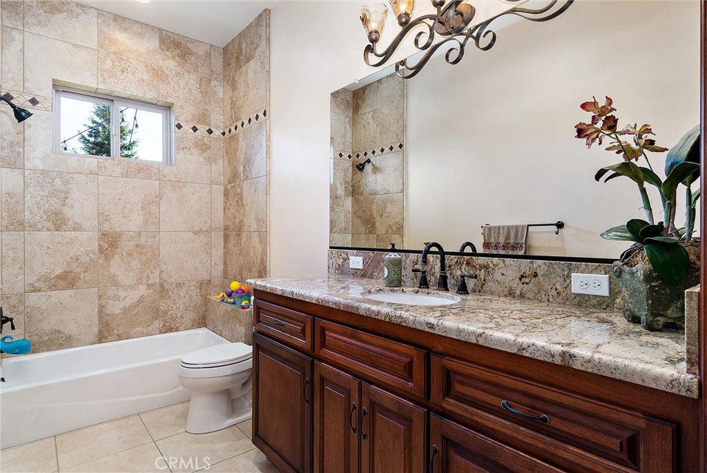 18205 Walnut Avenue Atascadero, CA 93422 - Photo 24 of 46 a bathroom with a granite countertop sink a toilet and a bathtub