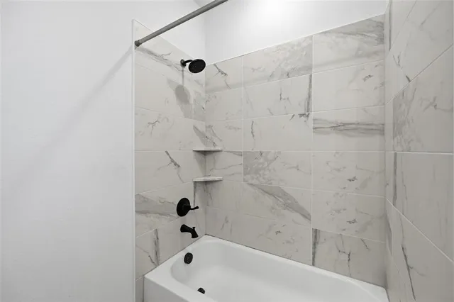 a view of empty room with wooden floor and ceiling fan