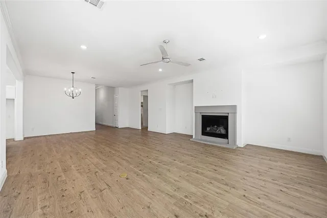 a view of a kitchen with a stove cabinets a ceiling fan and wooden floor
