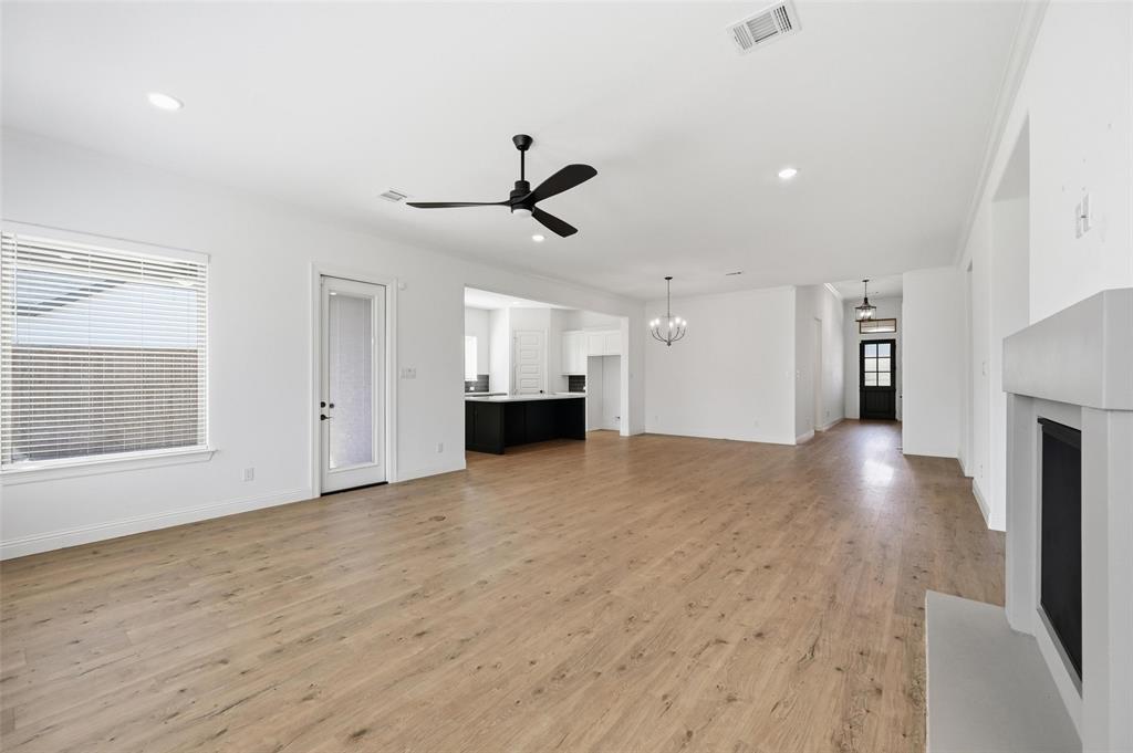 513 Fieldstone Lane Haslet, TX 76052 - Photo 14 of 18 a view of empty room with wooden floor and ceiling fan