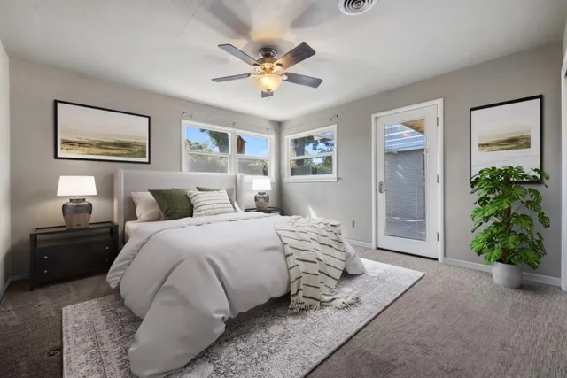 a spacious bedroom with a bed and a chandelier