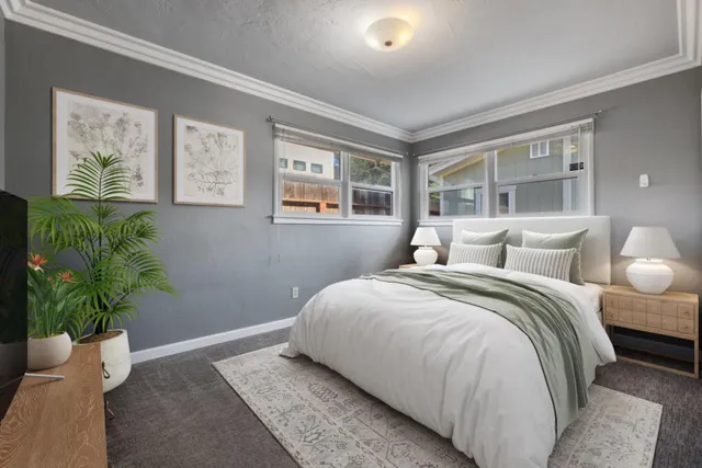 a bedroom with bed and a potted plant