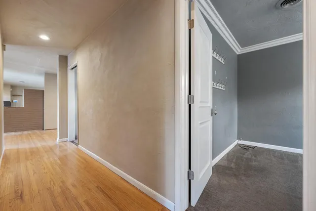 a view of hallway with wooden floor