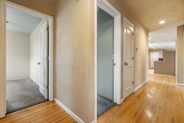 a view of a hallway with wooden floor