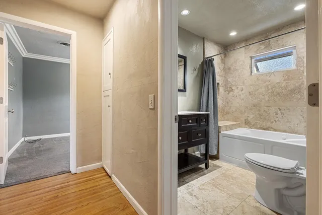 a bathroom with a toilet and a shower