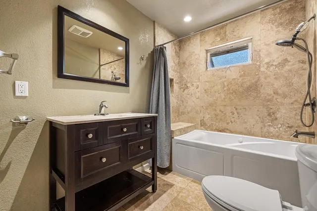a bathroom with a sink a toilet and bathtub