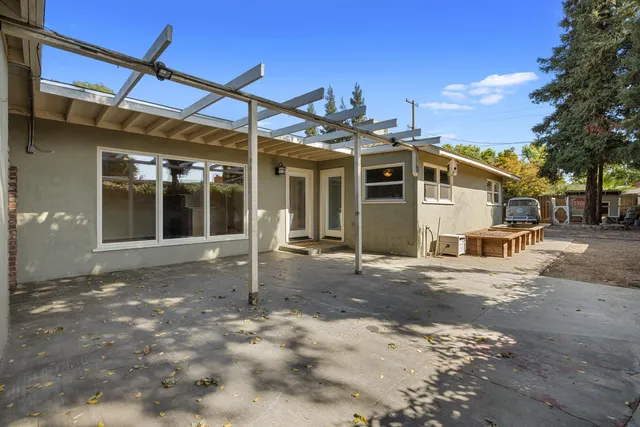 a backyard of a house with table and chairs