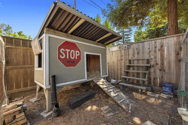 a view of a house with wooden fence