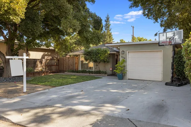 a view of a house with a yard and garage