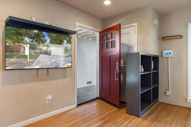 a view of kitchen with stainless steel appliances granite countertop a refrigerator and a wooden floor