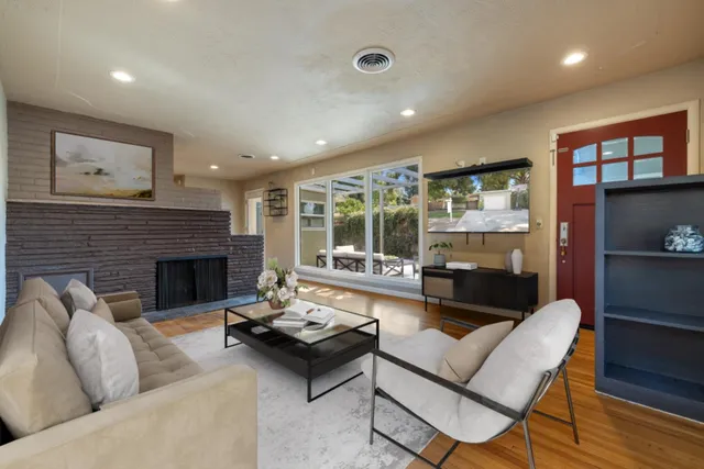 a living room with furniture and a fireplace