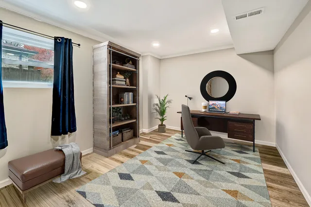 a living room with furniture a rug and white walls