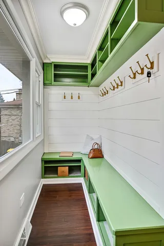 a room with green walls and stairs