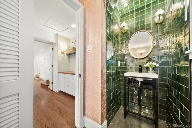 a bathroom with a sink mirror and a shower
