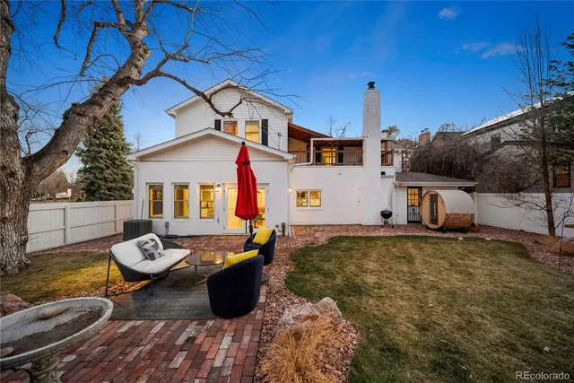 a backyard of a house with table and chairs