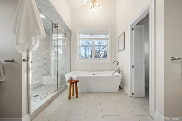a spacious bathroom with a bathtub and a shower