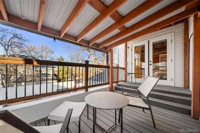 a view of a patio with a table and chairs